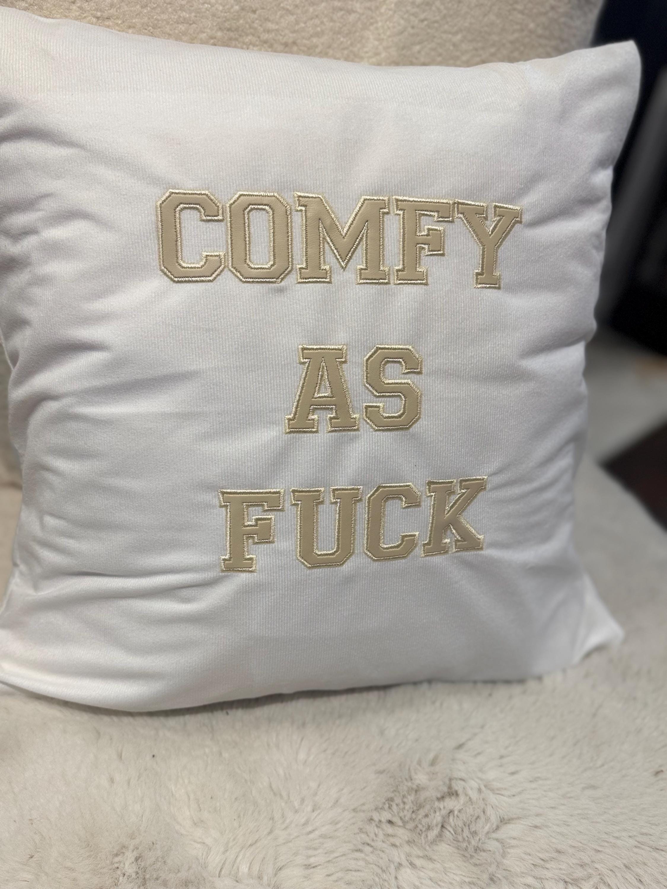 White cushion cover with ‘comfy as fuck’ in beige