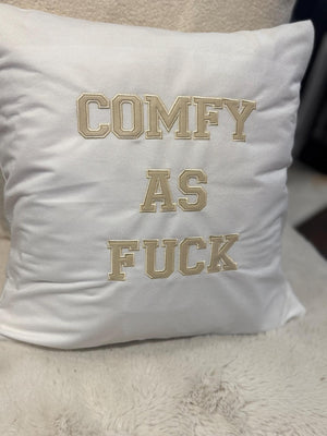 White cushion cover with ‘comfy as fuck’ in beige