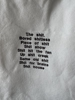 White tote bag with shit uk slang quotes embroidered in brown.