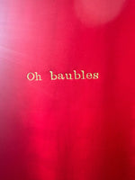 Christmas jumper in red, ‘Oh baubles’ embroidered in gold