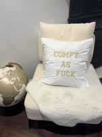 White cushion cover with ‘comfy as fuck’ in beige