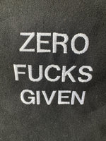 Black tote bag with ‘Zero fucks given’ embroidered in white.