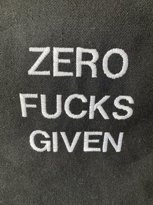 Black tote bag with ‘Zero fucks given’ embroidered in white.