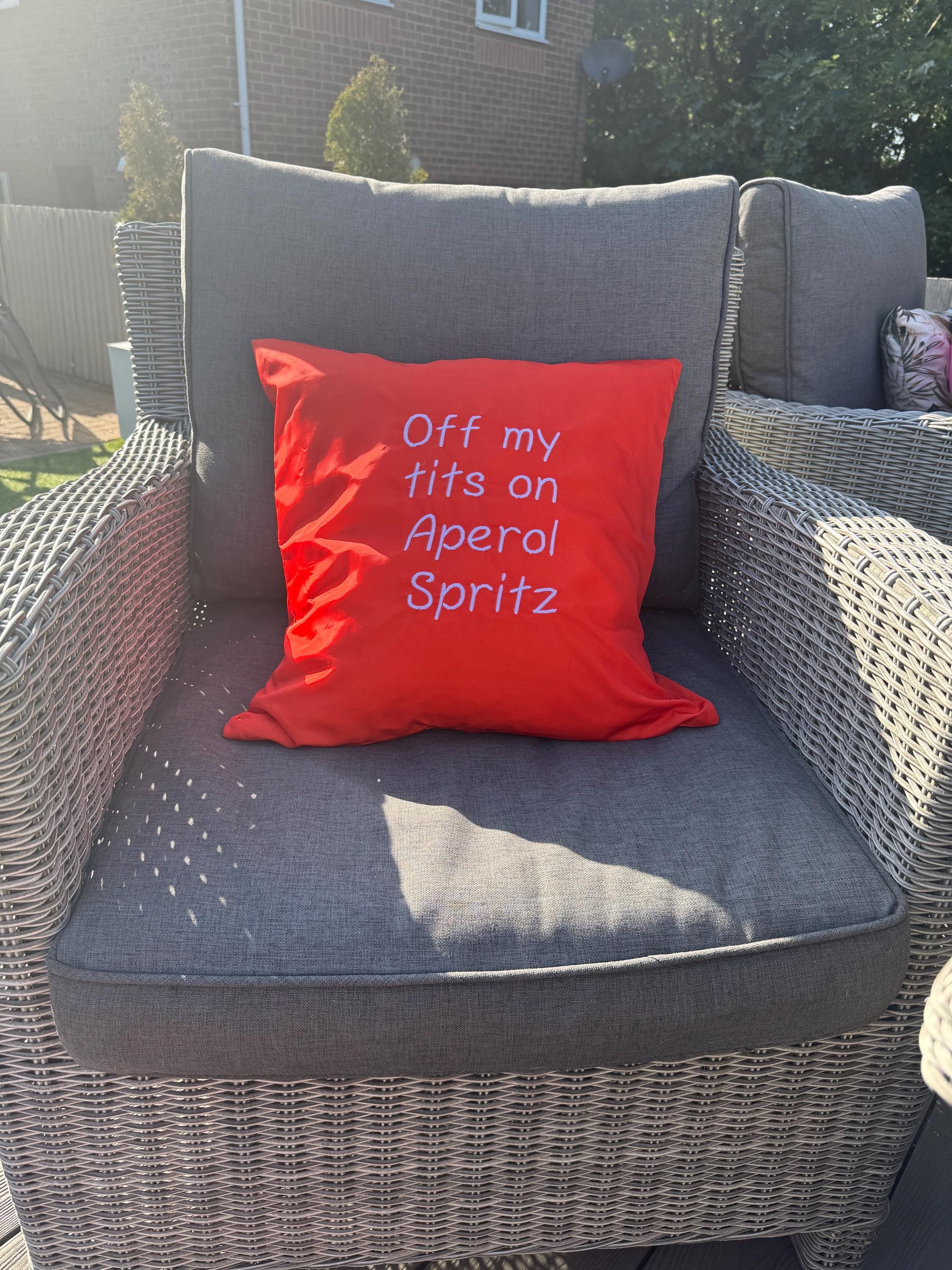 Orange square outdoor cushion cover with funny quote embroidered in white