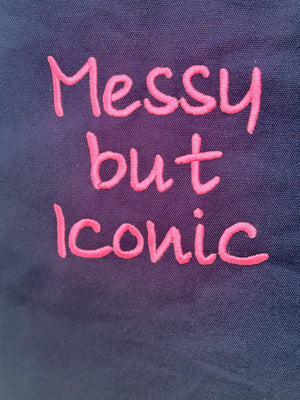 Black tote bag with ‘Messy but Iconic’ embroidered in neon pink
