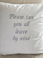 White cushion cover with ‘please can you all leave by nine’ embroidered in silver