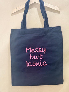 Black tote bag with ‘Messy but Iconic’ embroidered in neon pink